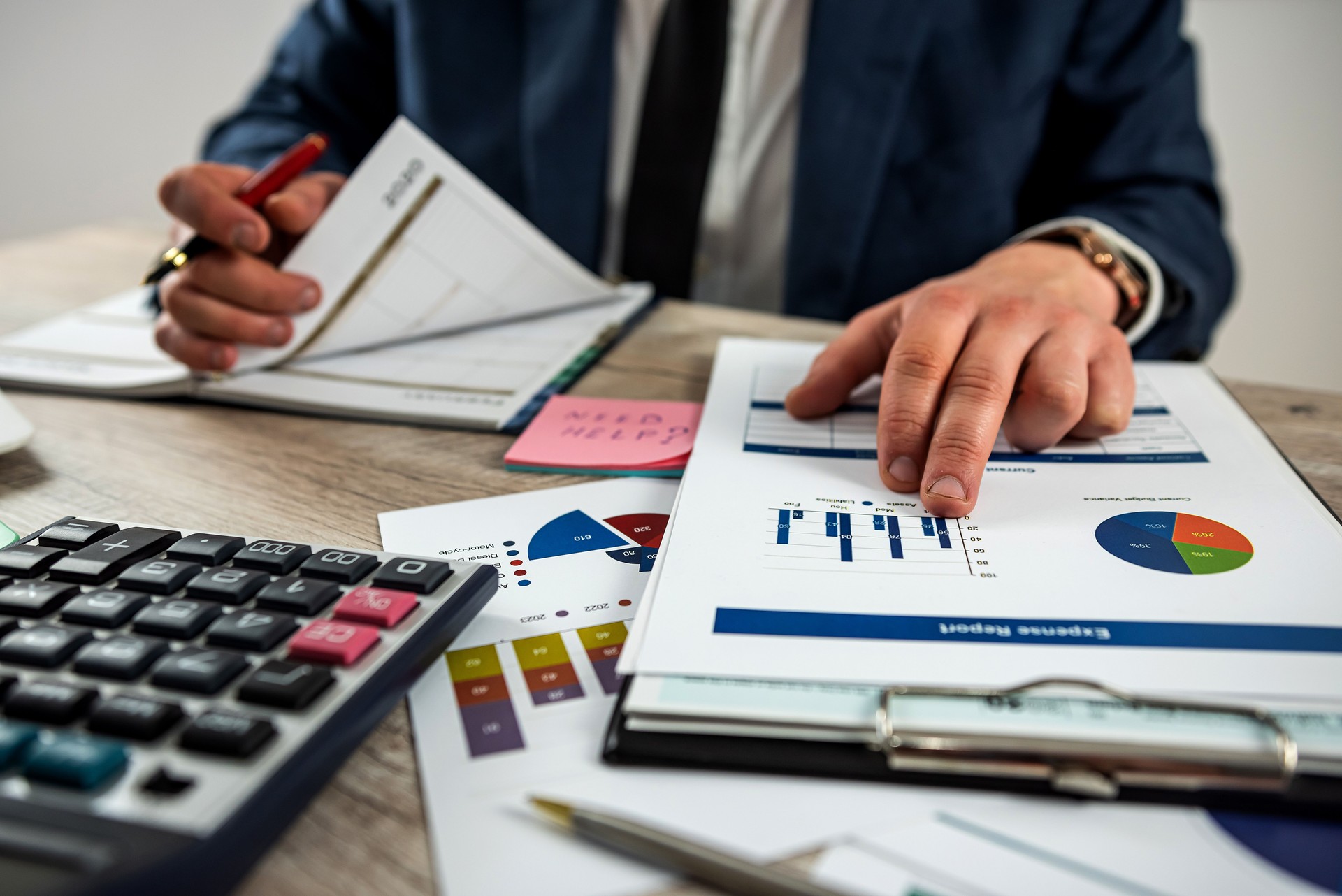 Business man using calculator for accounting finance chart and diagram